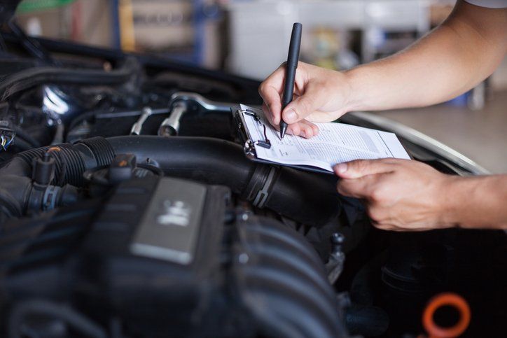 mechanic testing electronics in car